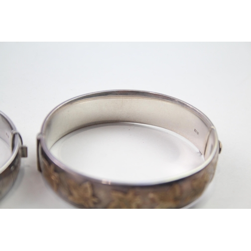 172 - Two silver bangles with gold accents and gemstone (61g)