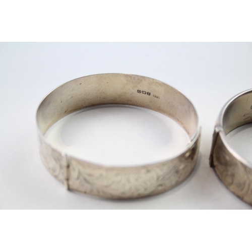 186 - Two silver bangles with etched designs (71g)