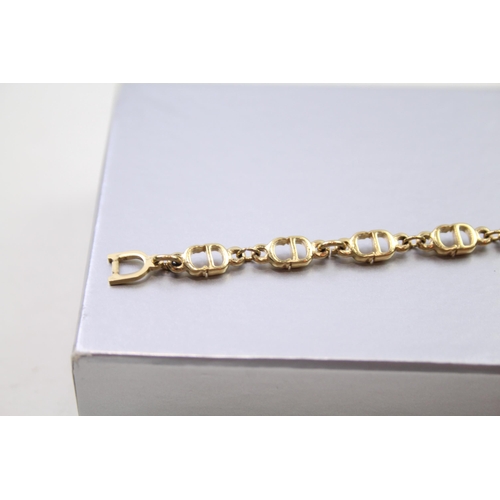 187 - Gold tone logo bracelet by designer Christian Dior in original box (6g)