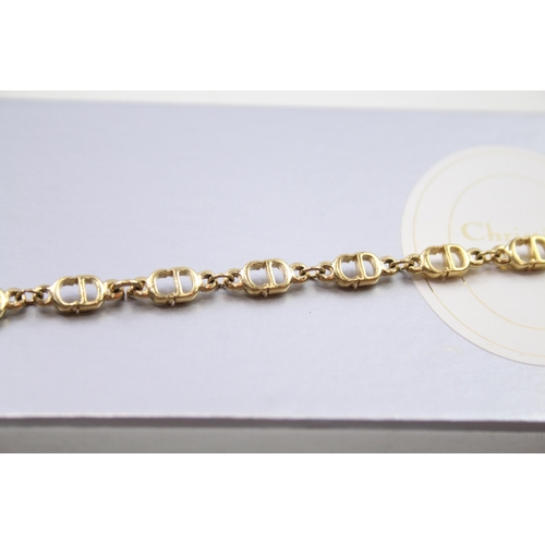 187 - Gold tone logo bracelet by designer Christian Dior in original box (6g)