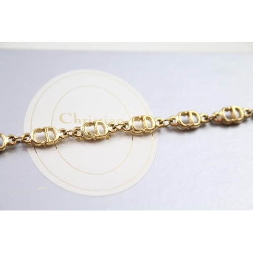 187 - Gold tone logo bracelet by designer Christian Dior in original box (6g)