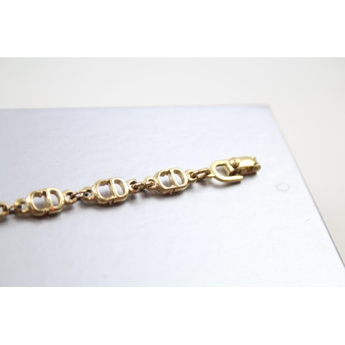 187 - Gold tone logo bracelet by designer Christian Dior in original box (6g)