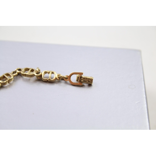 187 - Gold tone logo bracelet by designer Christian Dior in original box (6g)