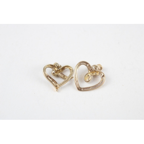 121 - 2x 9ct gold diamond heart pendants (2g)