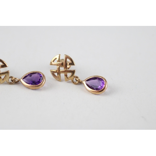 114 - 2x 9ct gold citrine & amethyst celtic earrings (2.8g)