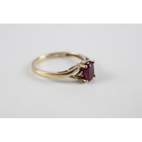 126 - 9ct gold red gemstone & diamond ring (1.8g) Size  M