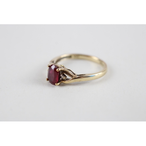 126 - 9ct gold red gemstone & diamond ring (1.8g) Size  M