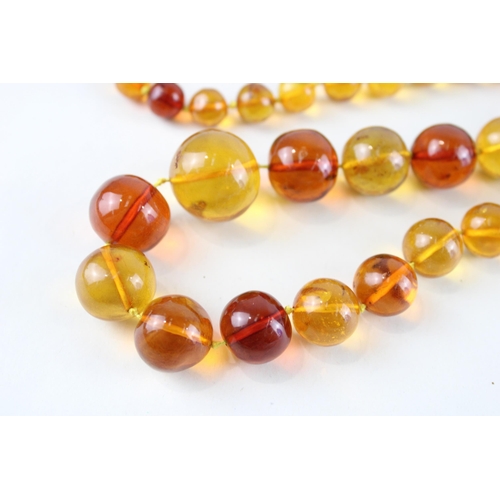 55 - 9ct gold amber necklace (71.9g)