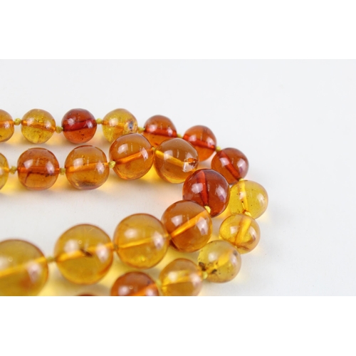 55 - 9ct gold amber necklace (71.9g)