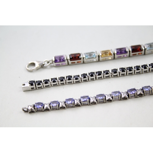 157 - Three silver gemstone tennis bracelets including Garnet (31g)