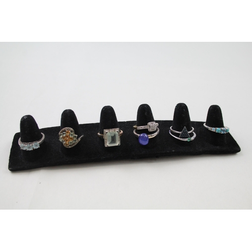 178 - A collection of silver gemstone rings including Emerald (24g)