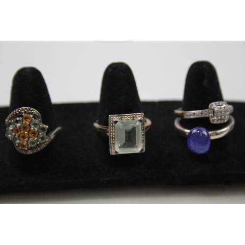 178 - A collection of silver gemstone rings including Emerald (24g)