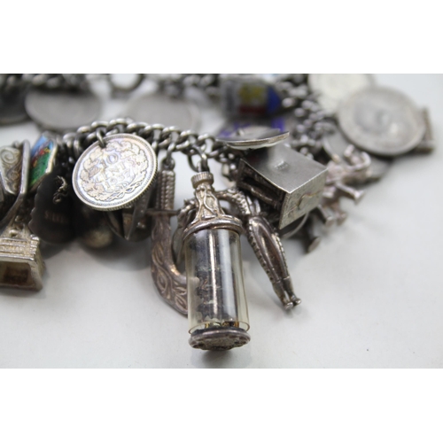 191 - Silver charm bracelet including coin charms (102g)