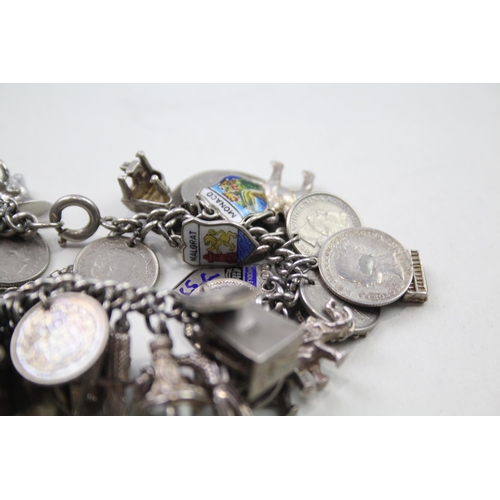 191 - Silver charm bracelet including coin charms (102g)