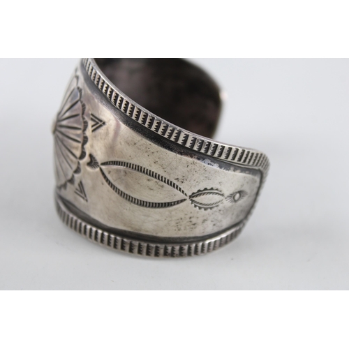 251 - A silver Native American design bangle (73g)