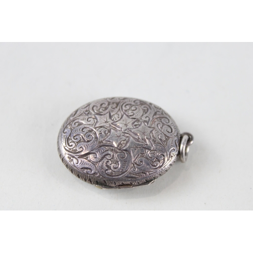 253 - A decorative Victorian silver bangle and locket (39g)