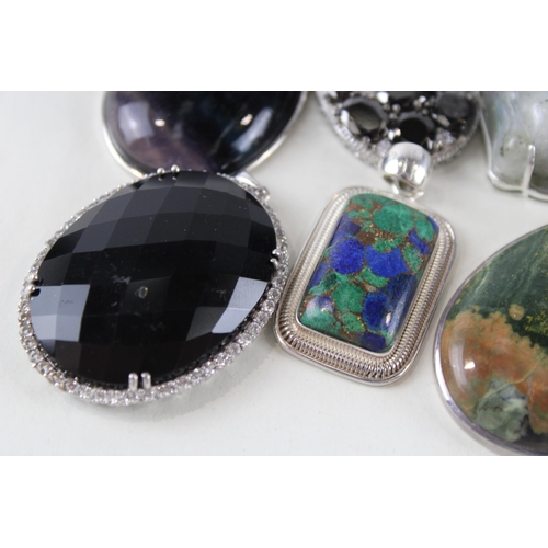 254 - Six silver mounted gemstone pendants (112g)