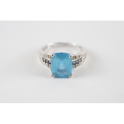 102 - 9ct gold blue topaz, sapphire & diamond dress ring (3g) Size  M + M