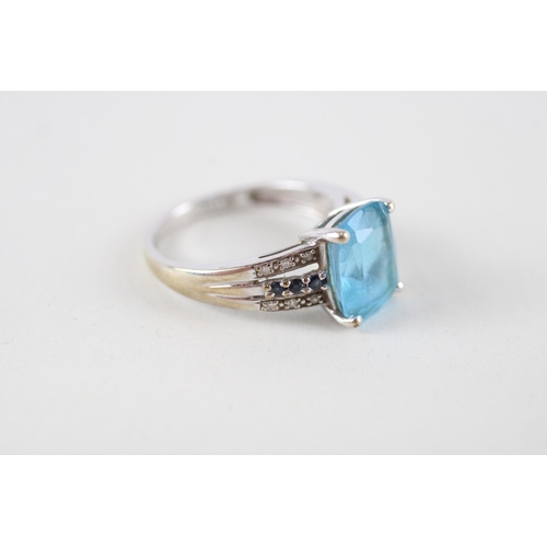 102 - 9ct gold blue topaz, sapphire & diamond dress ring (3g) Size  M + M