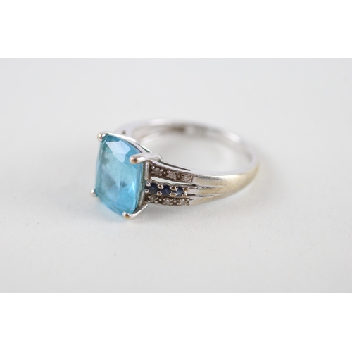 102 - 9ct gold blue topaz, sapphire & diamond dress ring (3g) Size  M + M