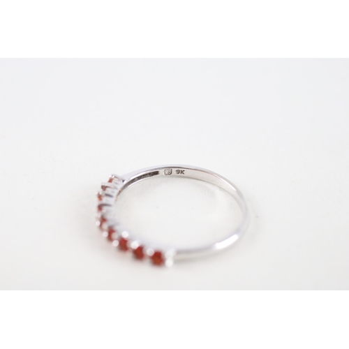 111 - 9ct white gold orange gemstone half eternity ring (1.2g) Size  M