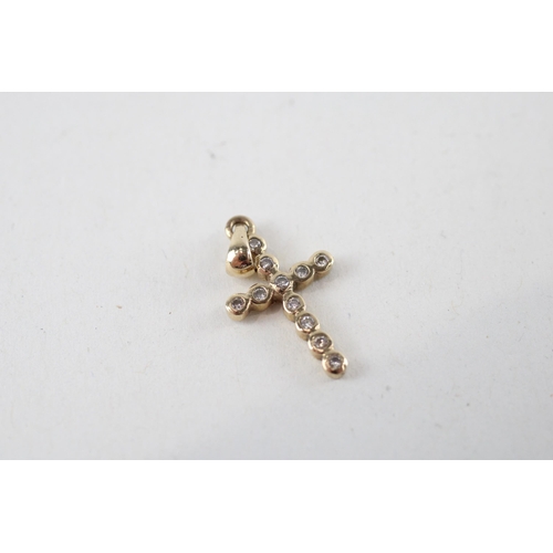 131 - 2 x 9ct gold white & yellow gold diamond cross pendants (1.5g)