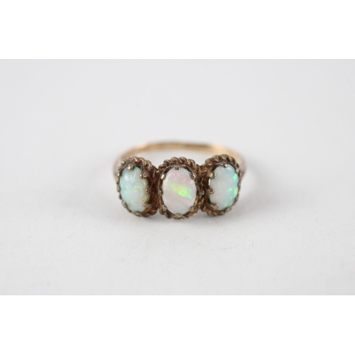 62 - 9ct gold opal three stone ring (2.8g) Size  R