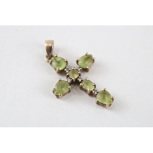 57 - 2 x 9ct white & yellow gold diamond & peridot cross pendants (3.1g)