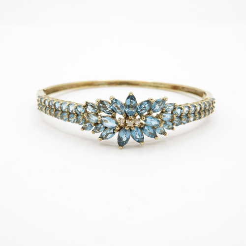 7 - HM 9ct gold bangle with blue stones (13.4g)