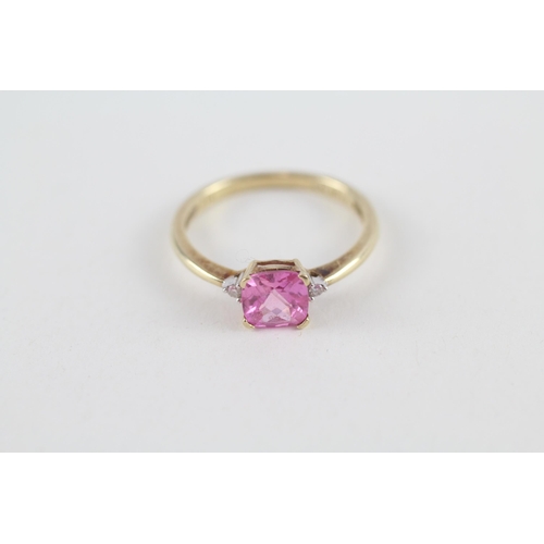 119 - 9ct gold pink sapphire single stone ring with diamond sides (1.9g) Size  O 1/2