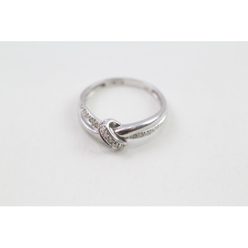 84 - 9ct white gold & diamond lovers knot ring (2.2g) Size  O