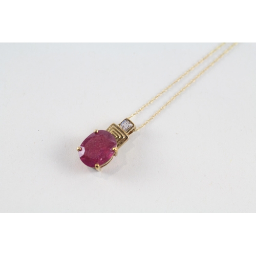 91 - 9ct gold glass filled ruby & diamond pendant & chain (2.7g)