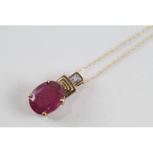 91 - 9ct gold glass filled ruby & diamond pendant & chain (2.7g)