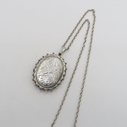 Antique locket in silver with silver chain - chain measures 60cm long - locket is 45mm long  29g