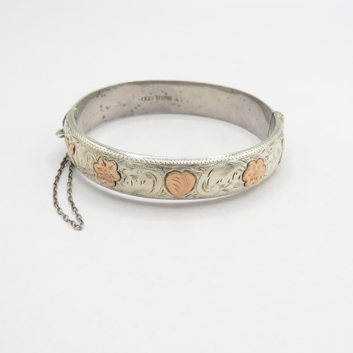 A hallmarked silver and gold bangle 20.8g