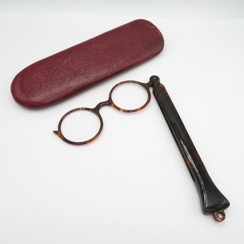 A set of faux tortoiseshell glasses in case