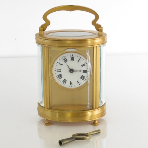 Oval midsized carriage clock.  Clock runs.  115mm x 90mm