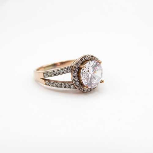 10 - HM 9ct rose gold dress ring with white CZ centre stone and white stone accents (4.1g) Size  P