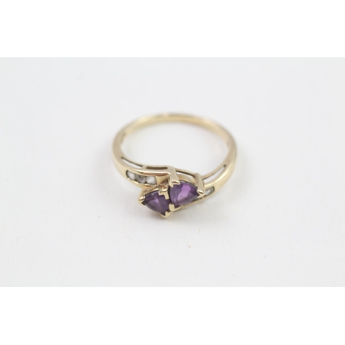 129 - 9ct gold amethyst two stone bypass ring with white gemstone set shank (2g) Size  N 1/2