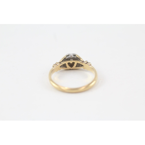 133 - 18ct gold diamond single stone ring with heart shaped set & floral shank (2.6g) Size  J 1/2