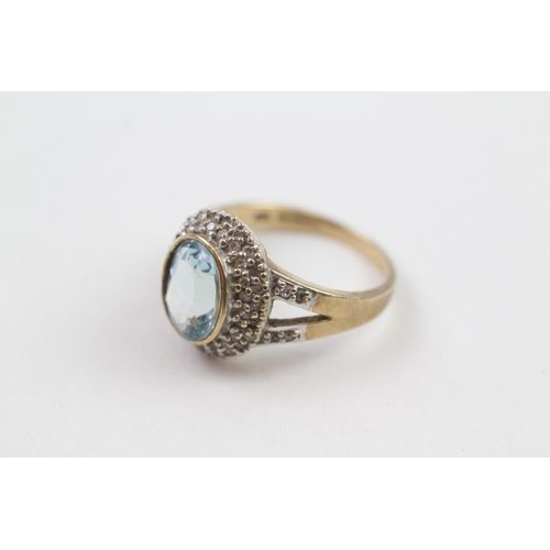 152 - 9ct gold blue topaz single stone ring with diamond frame & split shank (5g) Size  P