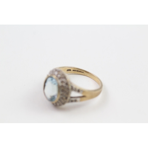 152 - 9ct gold blue topaz single stone ring with diamond frame & split shank (5g) Size  P