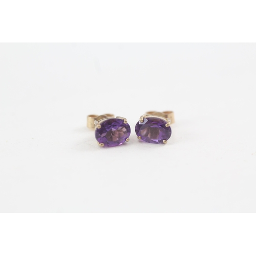 159 - 2 x 9ct gold amethyst stud earrings (3.3g)