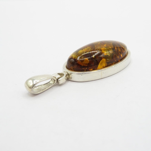 180 - Selection of silver and amber pendants HM  53.1g in total