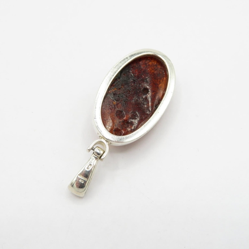 180 - Selection of silver and amber pendants HM  53.1g in total