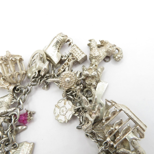 187 - Silver HM charm bracelet with selection of charms - some articulated  108.5g