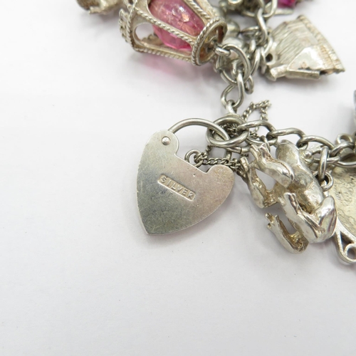 187 - Silver HM charm bracelet with selection of charms - some articulated  108.5g