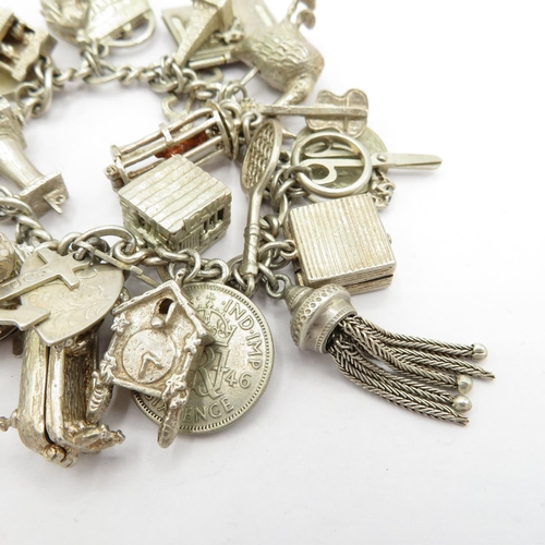 193 - Silver HM charm bracelet with selection of charms, some articulated  87.5g