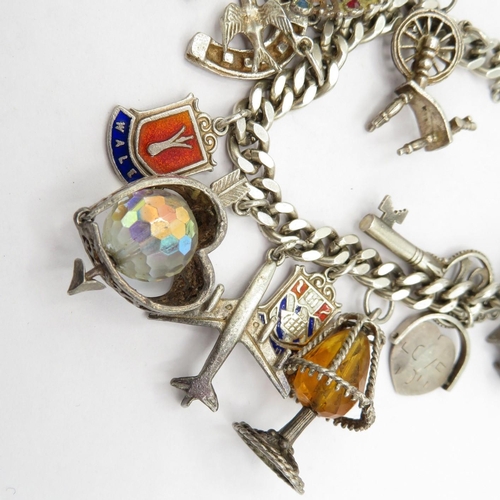 200 - Silver HM charm bracelet with selection of charms - some articulated 62.7g