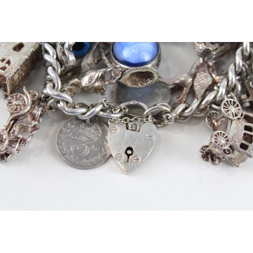 212 - Silver charm bracelet including souvenir charms (127g)